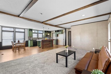 Living room featuring beamed ceiling, hardwood / w