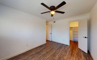 Unfurnished bedroom with dark wood-type flooring, 