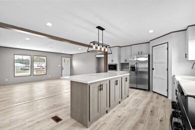 Kitchen featuring built in microwave, hanging ligh