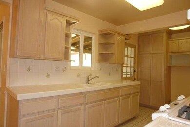 Modern cabinetry, ceramic tiled kitchen counters, 