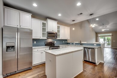 Kitchen with stainless steel appliances, pendant l