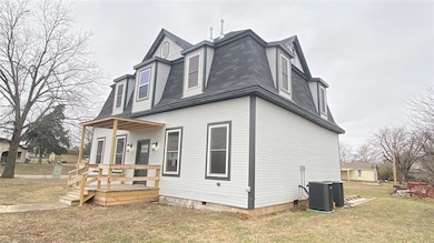 View of property exterior featuring roof with shin