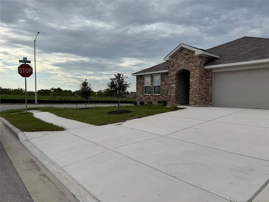 Single story home featuring brick siding, drivewa