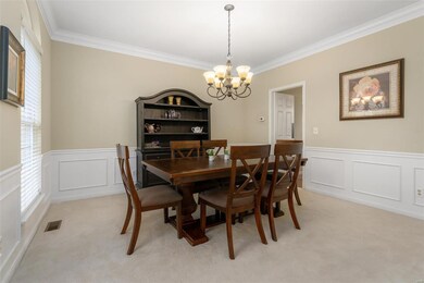 Formal dining room with crown molding & wainscotti
