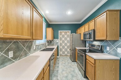 Kitchen with stainless steel appliances, a sink, 