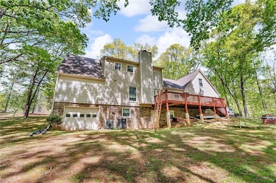 Rear view of property with dirt driveway, a chimne