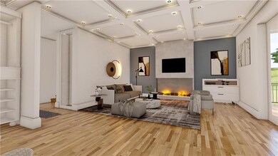 Living area featuring light wood-style flooring, coffered ceiling, healthy amount of natural light, a fireplace, and recessed lighting