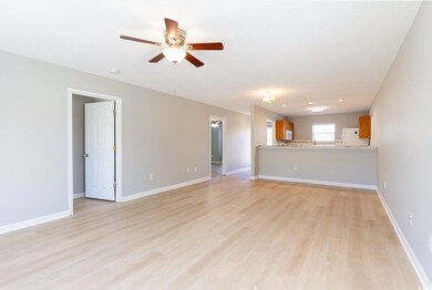 Unfurnished living room with a ceiling fan, basebo