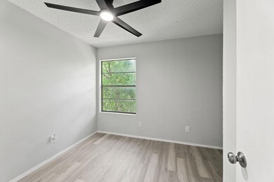Unfurnished room featuring a textured ceiling, li