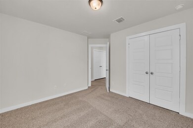 Unfurnished bedroom with carpet flooring, baseboa