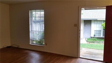 Unfurnished room with wood finished floors and baseboards