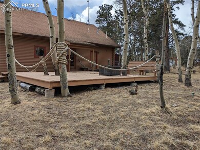 Back yard large deck, surrounded by aspen trees