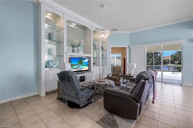 Tiled living room featuring ceiling fan and orname