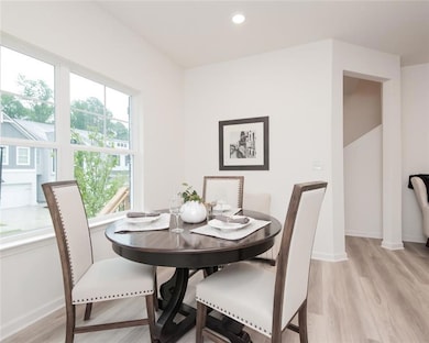 Dining room featuring light wood finished floors and recessed lighting