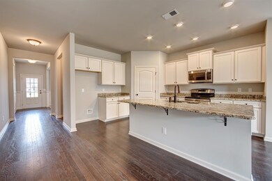 Second view of kitchen.  All photos are of a similar home, not of actual property listed
