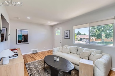 Living area featuring wood finished floors and recessed lighting