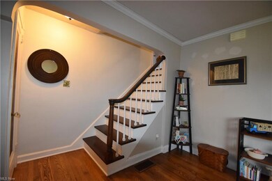 Stairs with ornamental molding and wood-type floor