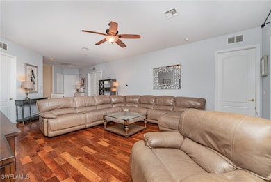 Living room with wood finished floors and a ceiling fan