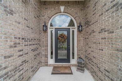 Property entrance featuring brick siding