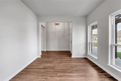 Unfurnished room with a chandelier and light wood-type flooring