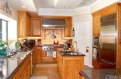 Gourmet kitchen with a custom tile back splash, gr