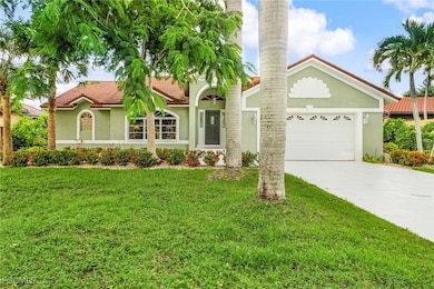 View of front of home with stucco siding, a tiled roof, driveway, a front lawn, and a garage