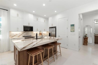 Kitchen with stainless steel fridge, a sink, taste