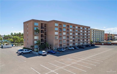 View of building exterior featuring uncovered parking