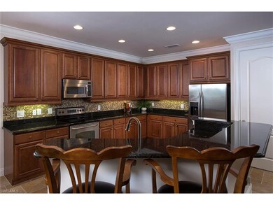 Spacious kitchen with raised panel cabinets and st