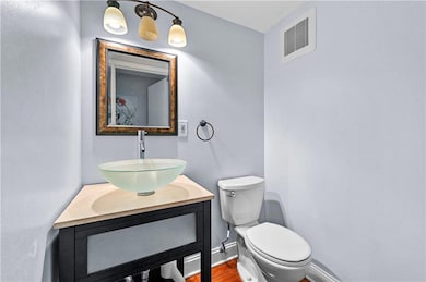 Bathroom with visible vents, wood finished floors,