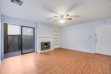 Unfurnished living room featuring ceiling fan, wo