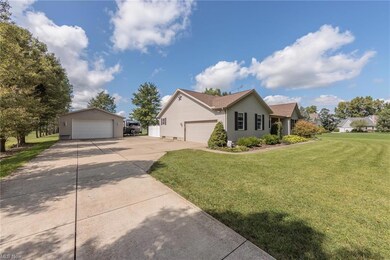 Ranch-style house with garage and a front lawn