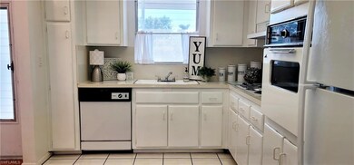 Kitchen featuring white cabinetry, white appliance
