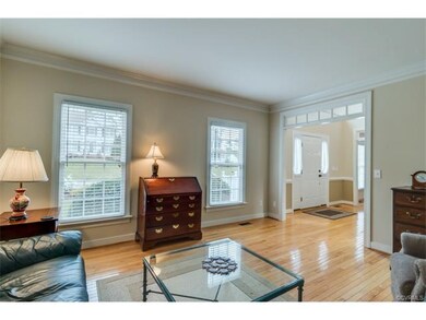 Light and bright formal living room with crown mol