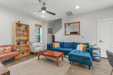 Living area featuring ceiling fan, light wood-typ
