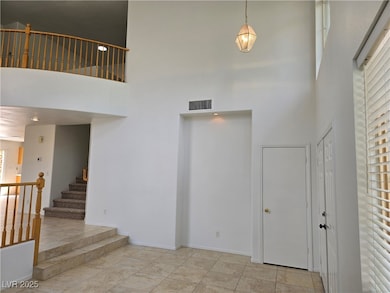 Entryway with a towering ceiling and stairs