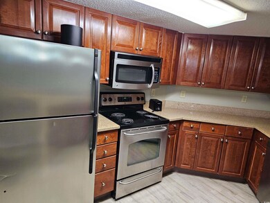 Kitchen featuring light wood-type flooring, a text