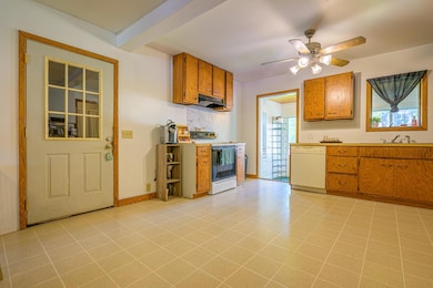 A mudroom connects the garage to the kitchen, and a four-season porch sits at the back of the home.