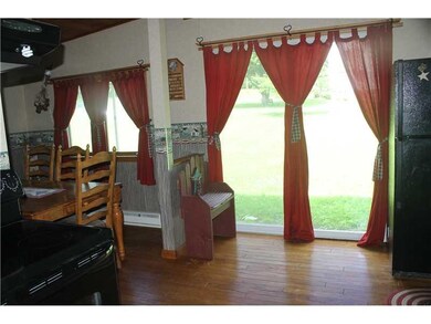 Kitchen. Lots of nature light - hardwood floors an