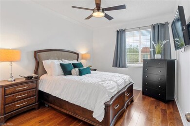 Bedroom with crown molding, wood-type flooring, and ceiling fan