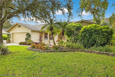 View of front of property featuring stucco siding, an attached garage, a front lawn, and driveway