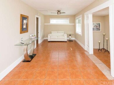 Living room with ceiling fan and tile flooring