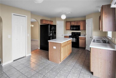 Kitchen with center island and multiple pantry sto