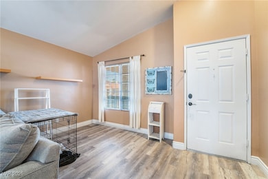 Foyer entrance featuring baseboards, wood-style fi