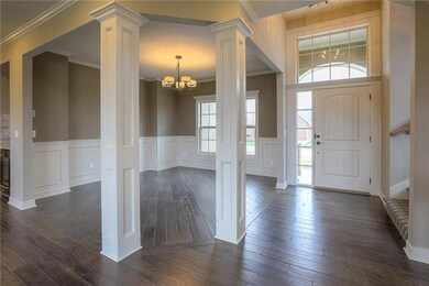 Gleaming dark hardwoods flow into the large dining