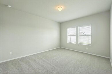 Spare room with carpet floors and a smoke detector
