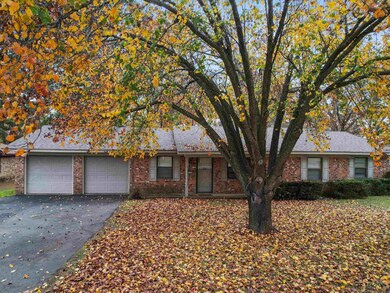 Single story home featuring brick siding, driveway