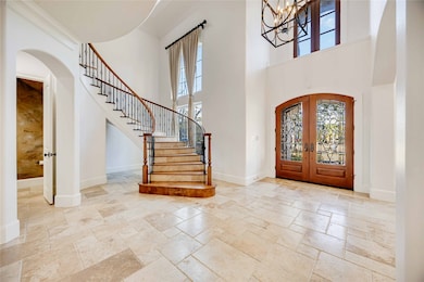 This elegant entryway features a grand curved stai