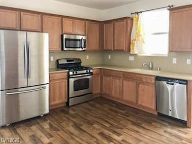 Kitchen with light countertops, dark wood finished