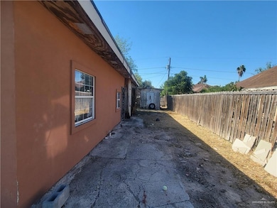 View of home's exterior featuring stucco siding, a storage shed, and a patio area